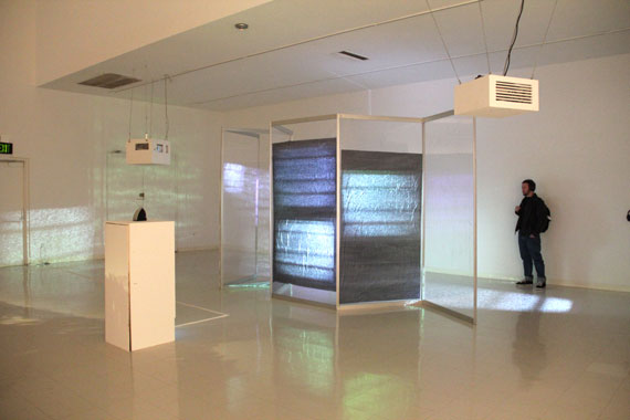 4-channel video installation, 2012; aluminum, plexiglas construction, garbage bags.